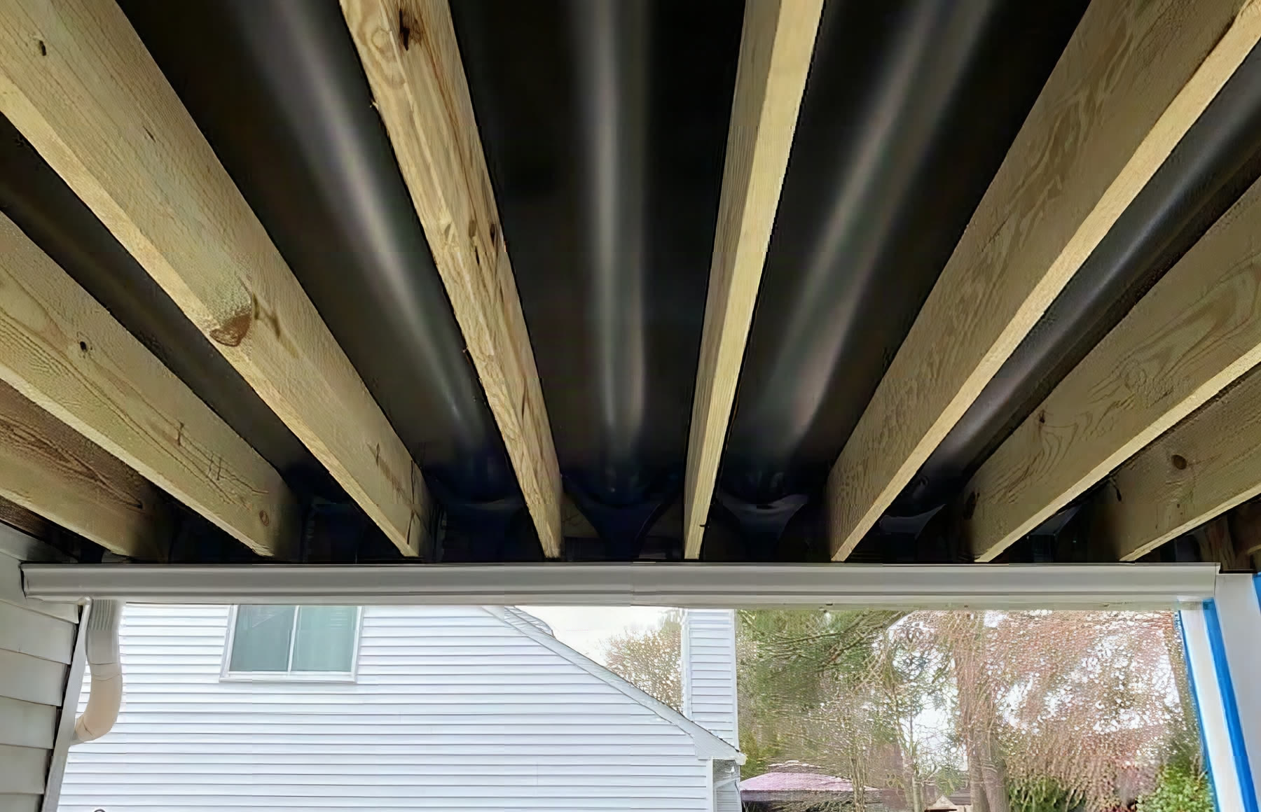 Deck framing with Trex RainEscape drainage installed between the joists before decking goes down